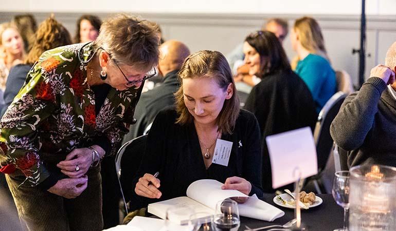 Associate Professor Emily O’Gorman signing her book, ‘Wetlands in a Dry Land: More-Than-Human Histories of Australia’s Murray-Darling Basin’.