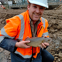 Man holding rainbow trout.